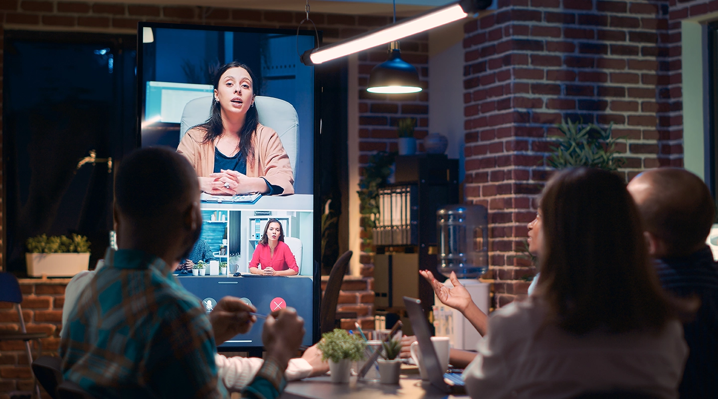 Illustration of a hybrid event with in-person attendees and remote participants joining online