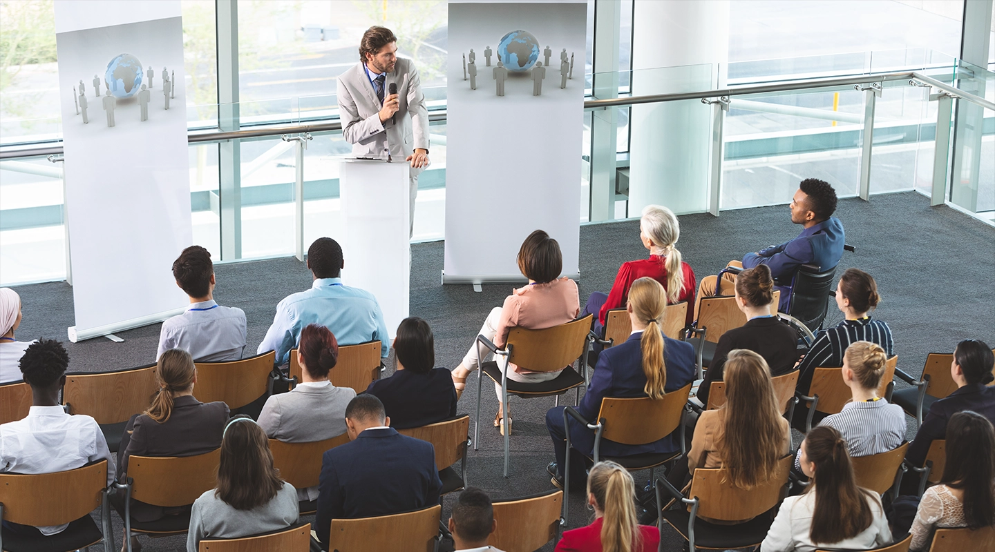 Industry-specific conference audience listening to speakers and meeting peers